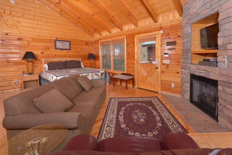 Pigeon Forge Cabin Rental Living Room Area that features a gas fireplace-flat screen television-sleeper sofa