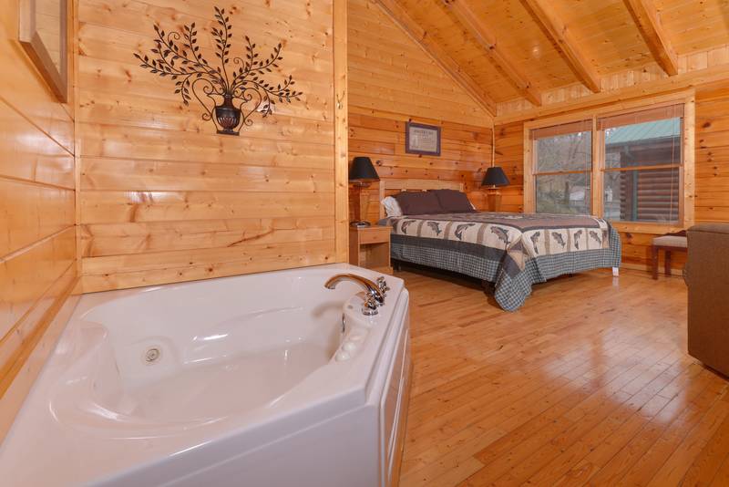 Pigeon Forge Honeymoon Cabin Rental that features a King Size Bed and Whirlpool