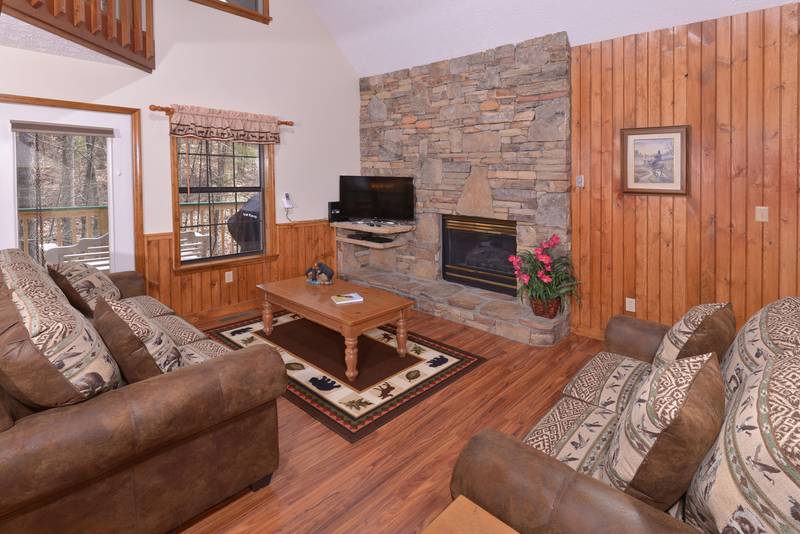 Pigeon Forge Two Bedroom Cabin Rental that features a Gas Fireplace and a Smart Flat Screen Television