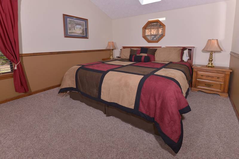 Smoky Mountain Two Bedroom Cabin Rental Upper Level Bedroom Featuring a King Size Bed