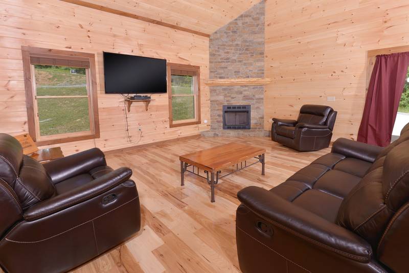 Amazing Grace Three Bedroom Cabin Rental features a gas burning fireplace