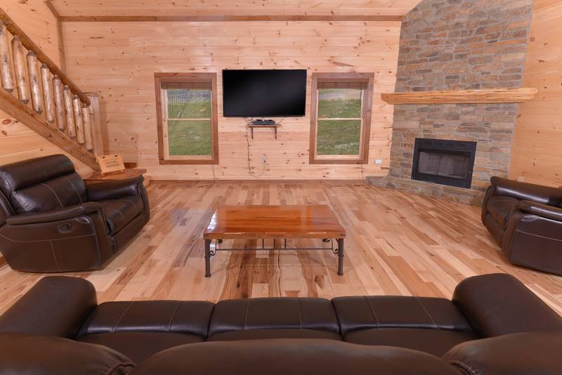 Main Level Livingroom Area features beautiful woodwork,gas fireplace, and flat screen television