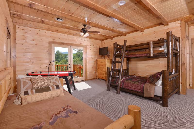 This Luxury Pigeon Forge Family Retreat Cabin Rental offers a Bunk bed in the upper level loft area