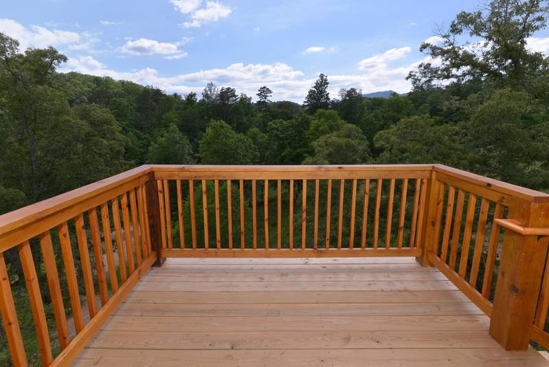 This is an upper level deck area that offers stairs that leads down to the main level