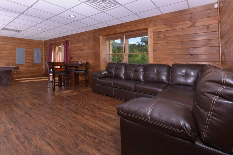 This Pigeon Forge Vacation Cabin Rental Offers a Lower Level Area Gameroom Seating Area