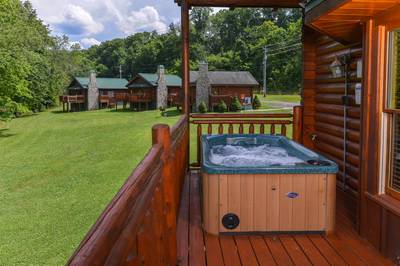 River Cabin back deck with hot tub