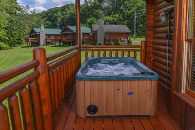 River Cabin back deck with hot tub