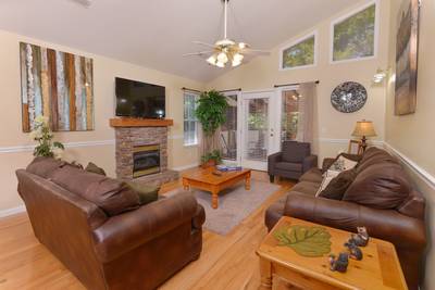 Striking Waters living room with stone encased gas fireplace