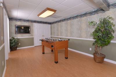 Whispering River lower level game room with foosball table