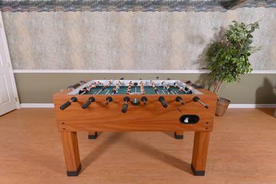 Whispering River lower level game room with foosball table