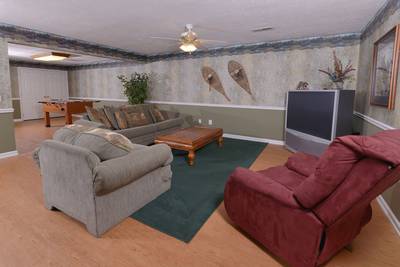 Whispering River lower level game room with recliner