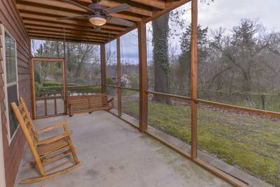 Whispering River lower level screened in back deck with swing