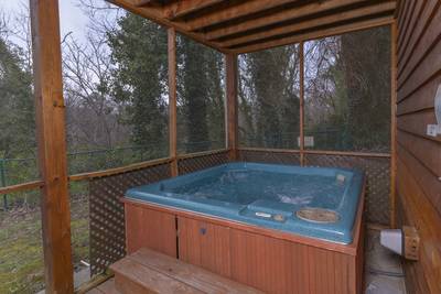 Whispering River lower level screened in back deck with hot tub