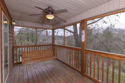 Whispering River main level screened in back deck with swing