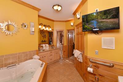 Crystal Waters main level bathroom one with 32-inch flat screen TV