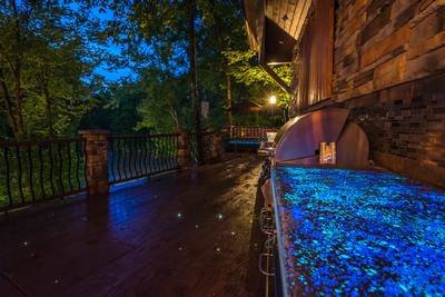 Crystal Waters main level outdoor kitchen with glowing countertops