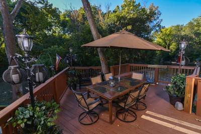Crystal Waters lower level back deck with table and chairs