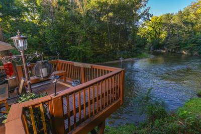 Crystal Waters lower level deck overlooking Little Pigeon River