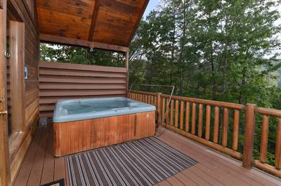 A Walk in the Clouds lower level covered back deck with hot tub