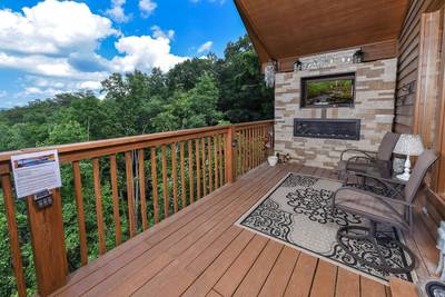 Cabin Fever covered back deck with electric fireplace