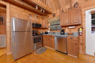 Beary Beary Special fully furnished kitchen with stainless steel appliances and granite countertops