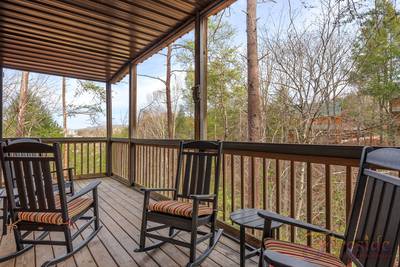 Best Time Ever covered back deck with rocking chairs