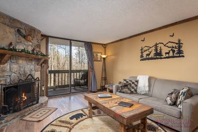 Rustic River living room with wood burning fireplace