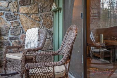 Rustic River bak patio with rocking chairs