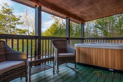 Winter Ridge covered entry deck with sitting area and hot tub