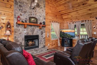 Three Bears main level living room with stone encased seasonal gas fireplace