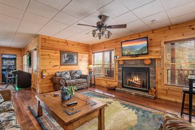 A Cabin of Dreams lower level sitting area with gas fireplace