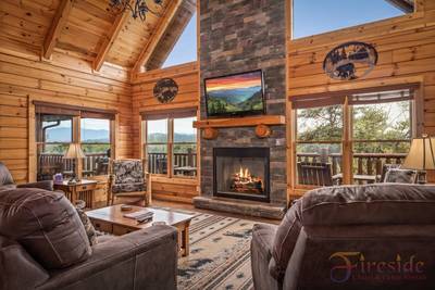 A Cabin in the Smokies living room with stone encased gas fireplace