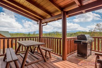 A Cabin of Dreams covered deck with gas grill