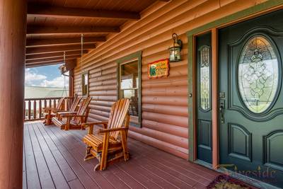 A Cabin of Dreams covered entry deck with swing