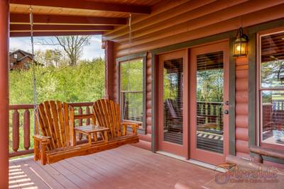 A Cabin of Dreams covered deck with swing