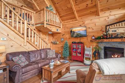 A Walk in the Clouds lower level living room with 50-inch flat screen TV