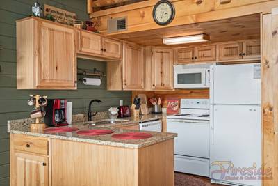 A Walk in the Clouds fully furnished kitchen with granite countertops