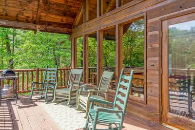 A Walk in the Clouds lower level covered back deck with rocking chairs