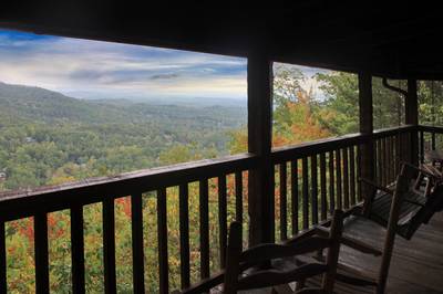 Old Glory covered deck with rocking chairs, swing and mountain views