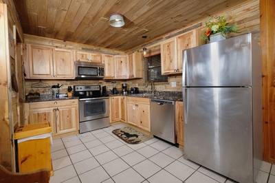 Country Charm fully furnished kitchen with granite countertops and stainless steel appliances