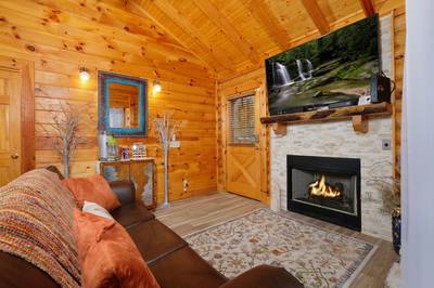 Dancing Waters living room with seasonal gas fireplace