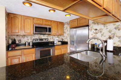 Adele's Retreat fully furnished kitchen with granite countertops and stainless steel appliances