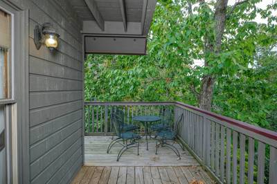 Adele's Retreat main level wraparound deck with metal table and chairs