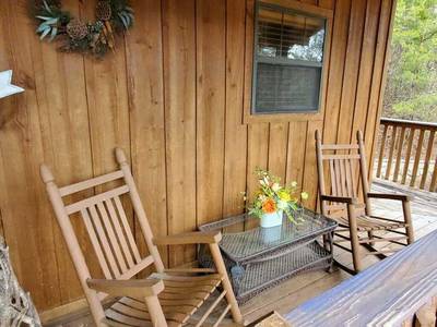 Country Charm wraparound deck with rocking chairs