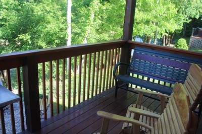 Lighthouse Harbor covered back deck with wood gliders and bench