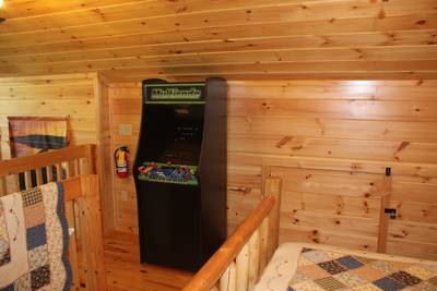River Haven upper level open loft bedroom with stand up arcade machine