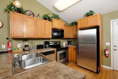 Timber Tree Lodge fully furnished kitchen with stainless steel appliances