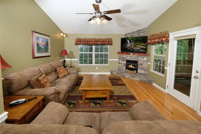 Timber Tree Lodge main level living room with stone encased seasonal gas fireplace