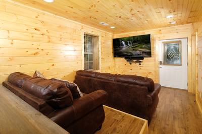 Timber Tree Lodge theater room with 75-inch flat screen tv