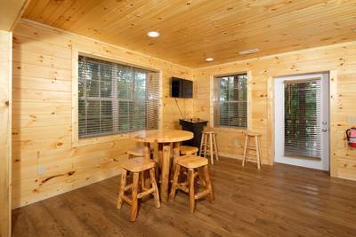 Timber Tree Lodge game room area with stand up arcade machine